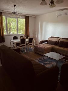 a living room with a couch and a table and chairs at Holiday Villa Abu Ibrahim in Bihać