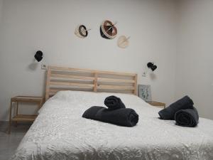 a bed with black towels on top of it at Kanela House in Nea Kalikratia