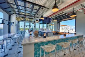 a bar in a seafood restaurant with tables and chairs at Hotel Effie Sandestin Resort, Autograph Collection in Destin