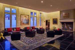 a large living room with couches and a fireplace at Hôtel de Bourgtheroulde, Autograph Collection in Rouen