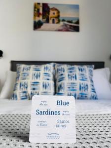 a white sign sitting on top of a bed at Blue Sardines in Pythagoreio