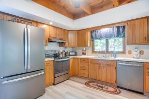a kitchen with wooden cabinets and stainless steel appliances at McGaheysville Home with Screened Porch and Gas Grill! in McGaheysville
