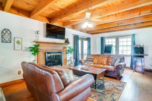 a living room with leather furniture and a fireplace at McGaheysville Home with Screened Porch and Gas Grill! in McGaheysville