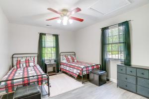 a bedroom with two beds and a ceiling fan at McGaheysville Home with Screened Porch and Gas Grill! in McGaheysville
