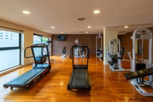 a gym with two tread machines in a room at Howard Johnson Plaza Jujuy in San Salvador de Jujuy