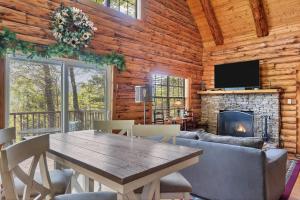a dining room with a table and a fireplace at Heavenly View in Townsend