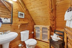 a bathroom with a toilet and a sink in a log cabin at Heavenly View in Townsend +39 photos