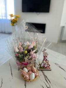 a vase filled with eggs and flowers on a table at WhiteBoxApartment in Kyustendil