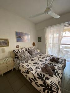 a bedroom with a black and white bed with a window at Villa V in Limne