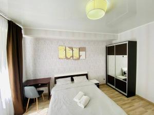 En eller flere senge i et værelse på Voyage 2 ROOMS Apartment