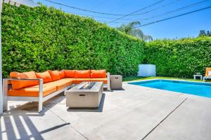 a couch sitting on a patio next to a pool at Sophia's Pool Oasis in Los Angeles