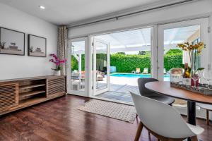 a living room with a table and chairs and a pool at Sophia's Pool Oasis in Los Angeles