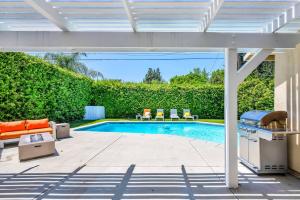a patio with a swimming pool and a pergola at Sophia's Pool Oasis in Los Angeles