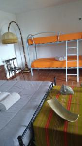 a bedroom with a bunk bed and a bed with shoes at Villa Bruno in Pisticci