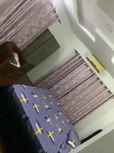 a bed in a room with crosses on it at CLASSIC SUITES ANNEX in Ilorin