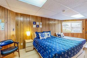 a bedroom with a bed and a chair in it at The Octagon on the Beach in Seaside