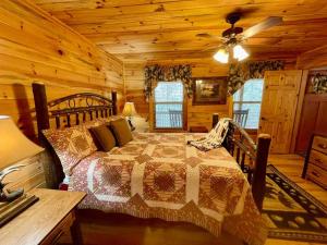a bedroom with a bed in a log cabin at Cabin 2 bed close to Helen hot tub #15 in Helen