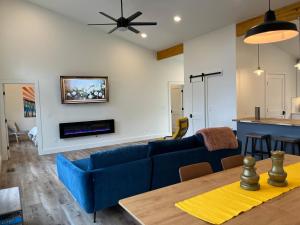 a living room with a blue couch and a table at Thunder Hollow in Ruidoso