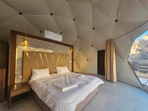 a bedroom with a large bed in a tent at Sunrise Luxury Camp in Wadi Rum