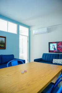 a conference room with a wooden table and blue chairs at Albanian Dream Escape Apartment in Golem