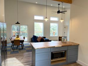 a kitchen and living room with a table and chairs at Thunder Hollow in Ruidoso