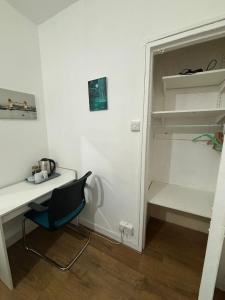 a room with a desk and a chair next to a closet at Fleetway Private Rooms in Central London in London
