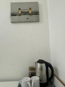 a kitchen counter with a tea kettle and two cups at Fleetway Private Rooms in Central London in London