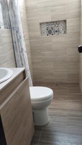 a bathroom with a toilet and a sink at El Hogar de Ami in Cali