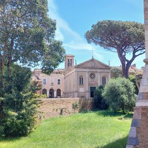 an old building with a church with a tree at La Malva in Ostia Antica