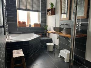 a bathroom with a tub and a sink at Grote gezinswoning in Rotterdam