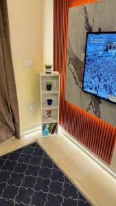 a corner of a room with a tv and a shelf at Relaxing Studio-Malibu El Sokhna Resort in Ain Sokhna
