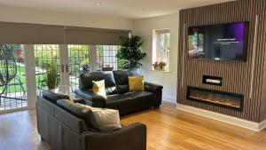 a living room with a couch and a fire place at Castlebar in Great Singleton