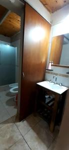 a bathroom with a sink and a toilet at Complejo Solitudine in Cacheuta