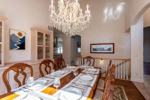 a dining room with a table and a chandelier at Luxurious 4BR Retreat - Pool Table & Chic Amenities in Boulder