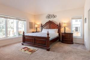 a bedroom with a large bed and two windows at Luxurious 4BR Retreat - Pool Table & Chic Amenities in Boulder
