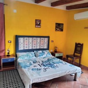 una camera con un letto e una parete gialla di Casa Vacanze Gorropu Tiscali a Dorgali