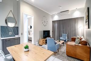 a living room with a table and a dining room at 2bedroom apartments at Menlyn Maine on 16th in Pretoria
