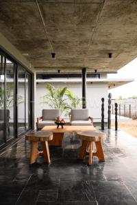 a living room with two tables and two chairs at Qalb in Mandya