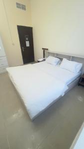 a large white bed sitting in a room at P3) Fantastic Seaview Room with shared bath inside 3bedroom apartment in Ajman 
