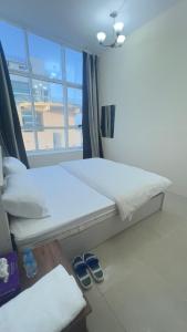a bedroom with a bed and a table and a window at P3) Fantastic Seaview Room with shared bath inside 3bedroom apartment in Ajman 