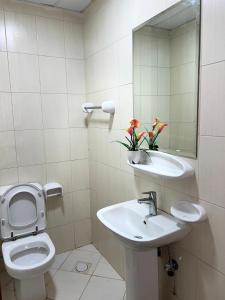 a bathroom with a toilet and a sink and a mirror at P3) Fantastic Seaview Room with shared bath inside 3bedroom apartment in Ajman 