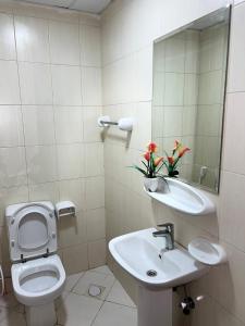 a bathroom with a toilet and a sink and a mirror at P3) Fantastic Seaview Room with shared bath inside 3bedroom apartment in Ajman 