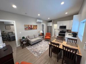 a kitchen and living room with a couch and a table at Stylish and cozy 2 bed in Brighton