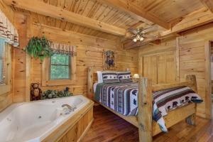 Cette cabane en rondins comprend un lit et une baignoire. dans l'établissement Bear Secrets cabin, à Sevierville
