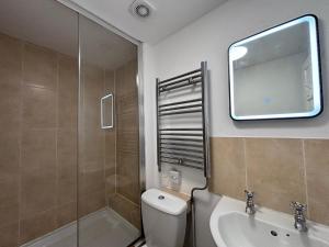 a bathroom with a toilet and a sink and a mirror at Haymarket Hostel in Edinburgh
