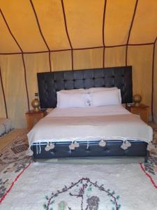 a bedroom with a bed in a tent at Luxury Desert Camp Merzouga in Merzouga