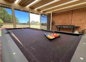 a billiard table in a living room with afits at Blue Willow Bathurst Country Getaway in Bathurst