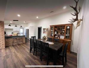 a kitchen and dining room with a table and chairs at Blue Willow Bathurst Country Getaway in Bathurst