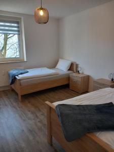 a bedroom with two beds and a window at City Apartment Duisburg Netflix &Wlan & Kingsize Bett & Big TV & Central in Duisburg