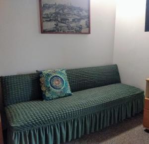 a green couch with a pillow on it in a room at Pension Archa in Znojmo